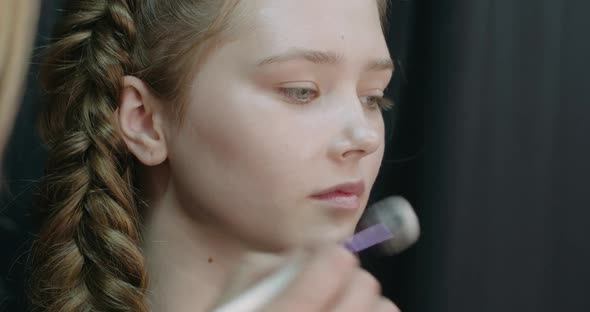 Portrait of a Pretty Girl Makeup Artist Applies Makeup for a Young Model Studio Shooting in Slow alt