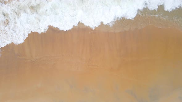 Aerial view top view beach and seawater on sandy beach in summer. Nature and travel alt