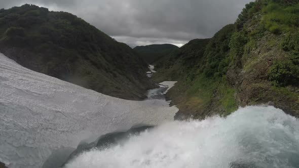 High Cascade Waterfall Falling in Snowfield