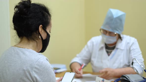 Female Patients Undergoing Questioning with Coronavirus Nurse During Pandemic alt