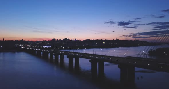 Beautiful Bridge Against the Sunset with Clouds Cars Go on the Bridge