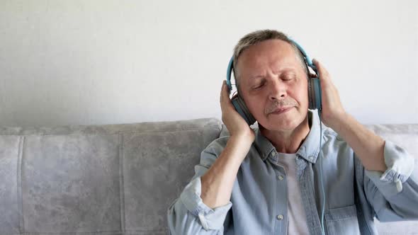 Cheerful Senior Retirement Gray Haired Man Listening Music on ...