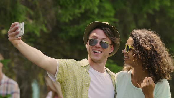 Happy Multicultural Friends Taking Selfie, Smiling for Camera at Outdoor Party alt