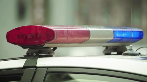 Flashing Flasher on the Roof of a Police Car. Blinker. Close-up. alt