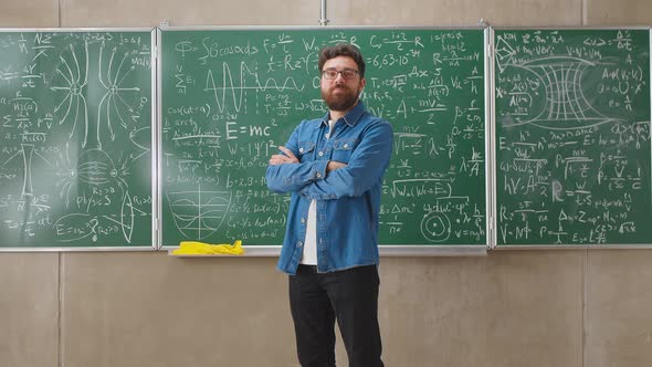 Portrait of Happy Young Man Student Standing in Class with Arms Crossed Smiling Looking at Camera alt