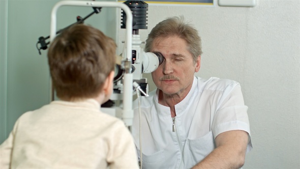 Optometrist doing sight testing for little pateient