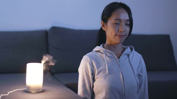 Woman Sitting at Home and Meditating 