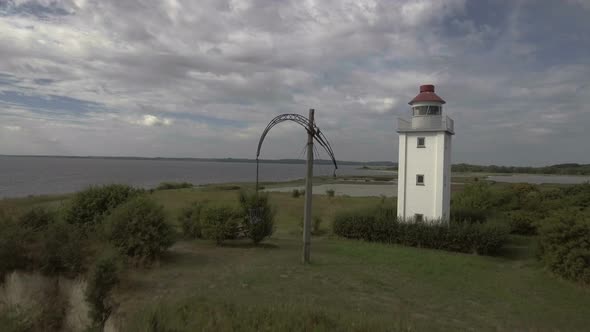 Lighthouse Drone Flies Low Over Water And Flies Up Over The Lighthouse