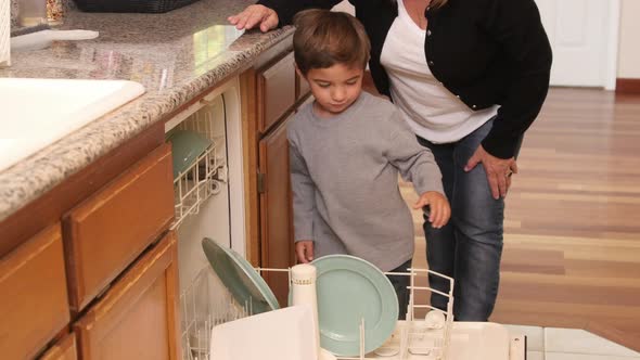 Mother and Son loading dishwasher together