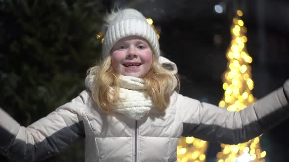 Beautiful Slow Motion Video - a Blonde Girl Throws Snow at the Camera