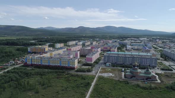 Aerial view of a small town with church among forests and hills. 04 alt