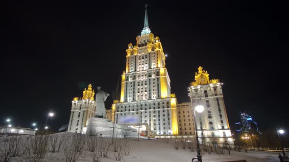 Hotel Ukraine Winter Night Timelapse Hyperlapse with Shevchenko Monument on Moscow River. alt