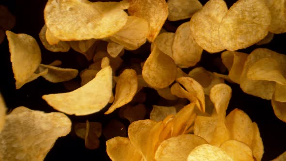 Super Slow Motion Shot of Potato Chips Flying Towards the Camera at 1000Fps alt