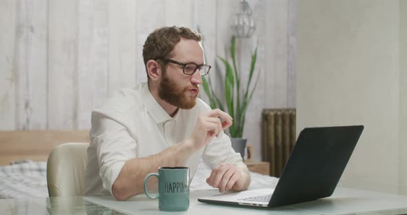 Attractive Man Talks on a Video Call and Starts Dancing with Maracas