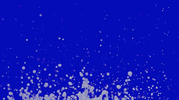 White Drops of Milk Fly Up and Spray in Different Directions on Blue Background alt