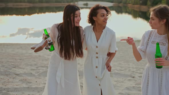 Group of Female Friends Having Fun at the Party on a Lake Beach