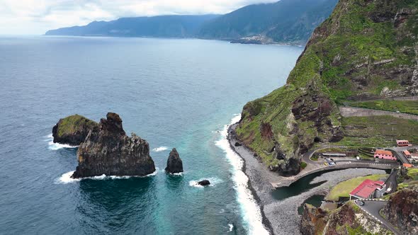 Aerial over rugged lava rock formations on coast, Porto Moniz, Madeira alt