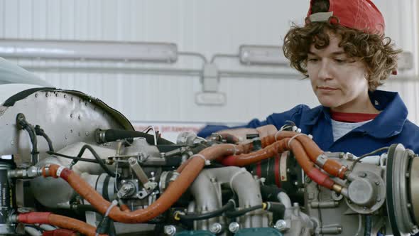 Female Technician Repairing Airplane alt