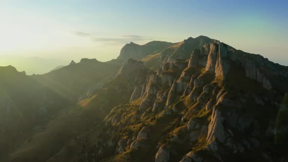 Drone view over Ciucas Peak at sunset, beautiful mountain scenery in Romania alt