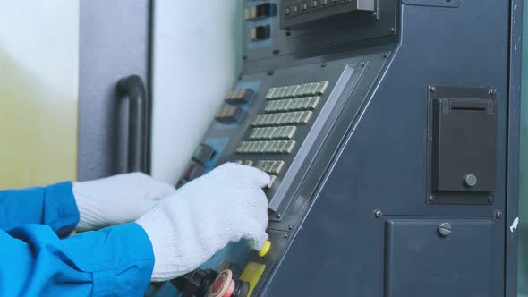 close up hand finger press button controling cnc machine alt