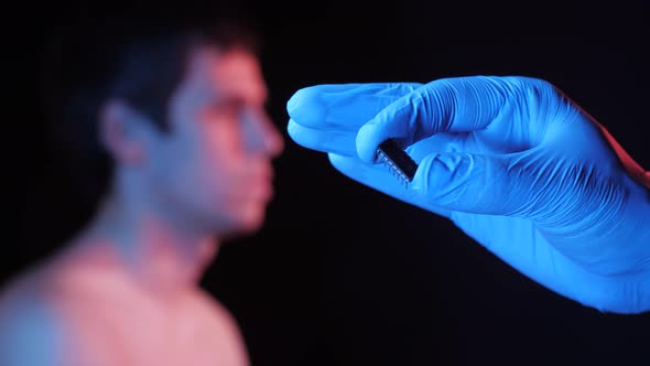 Physician Holds Chip for Implantation alt