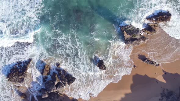 High Angle View of Waves Hitting Rocks on Shore