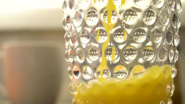 Closeup Video of Orange Juice Pouring Into Glass