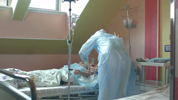 Nurse Preparing Female Patient Arm To Put IV Tube alt