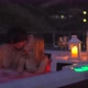 A Young Man and Woman are Relaxing in the Hot Tub on a Rooftop at Night - VideoHive Item for Sale