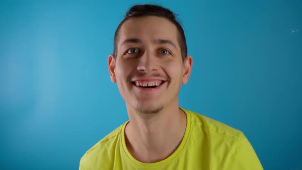 Young Man at the Camera and Showing Thumb Up alt