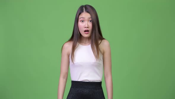Young Beautiful Asian Businesswoman Looking Shocked