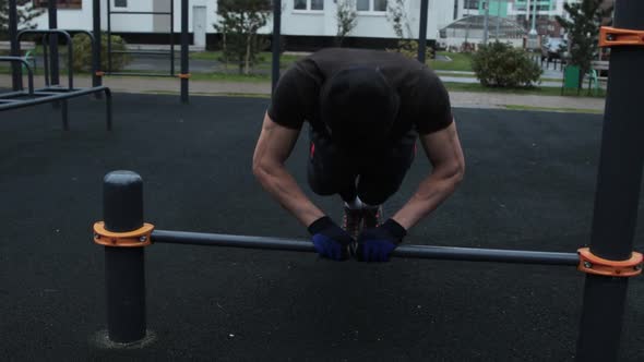 Muscular man training outdoors on sports field