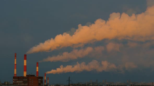 Smoke From Pipes in the Air. Large Pipes of Industrial Factory Produce Chemical Smoke in the Evening