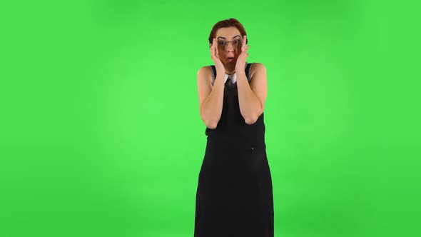 Funny Girl in Round Glasses with Fear and Horror Looking Forward. Green Screen alt