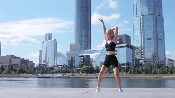 Woman dancing on street in city