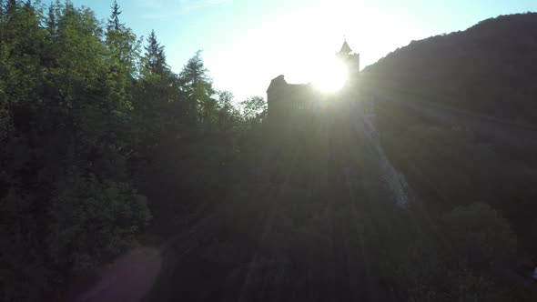 Aerial View of Sun Shining Behind Bran Castle
