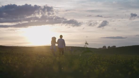 Family Outdoor Recreation a Boy with His Parents Running Through the Field Launching a Kite a Young alt