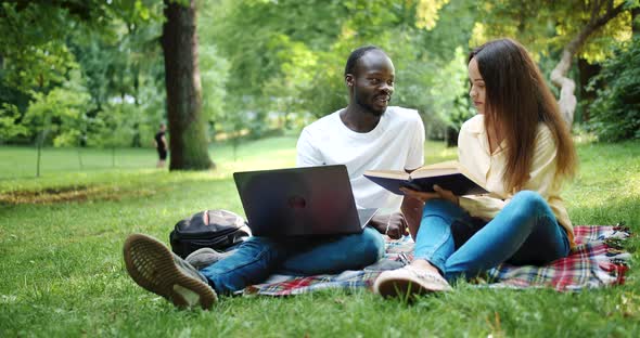 Multiracial Friends Studying in Park