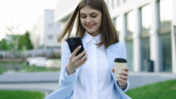 Business Woman Walking While Using Phone in Urban City Buildings Look Around Feel Happy Smile