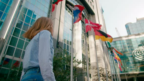 Lady Walks Along EU Flags to European Parliament Office in Brussels Belgium