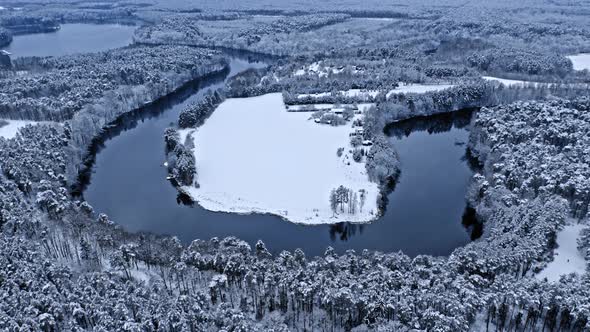 Aerial view of winter nature. Winter river and snowy forest. alt