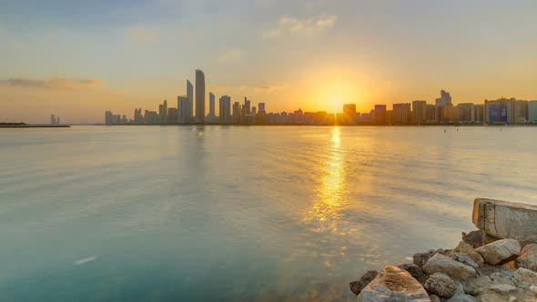 Abu Dhabi City Skyline on Sunrise Time with Water Reflection Timelapse alt