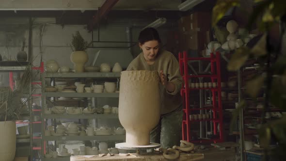 Woman Is Modeling Vase Walls of Raw Clay
