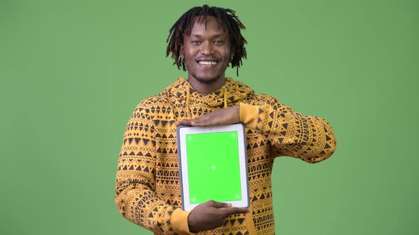 Young Happy Handsome African Man Showing Digital Tablet alt