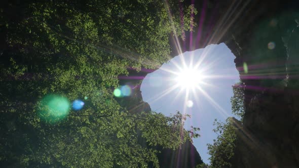 Slow motion  sun flares through Vratna gates  1080p FullHD footage - Eastern Serbia natural wonder s alt