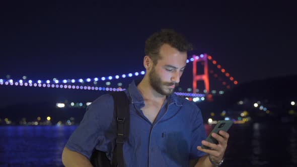 Happy teenager using phone. alt