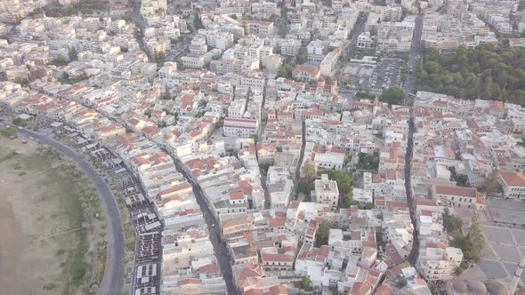 Aerial view Rethymno cityscape, sea coastline, road, boarts, lighthouse, port at sunset Crete Greece alt