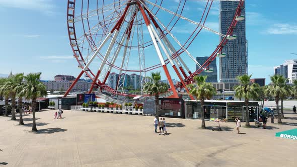 Aerial shot of Ferris wheel, alphabetic tower, skyscrapers and embankment of beautiful Batumi City alt