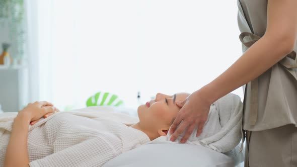 Asian young woman feel happy and relax during facial and head massage. alt