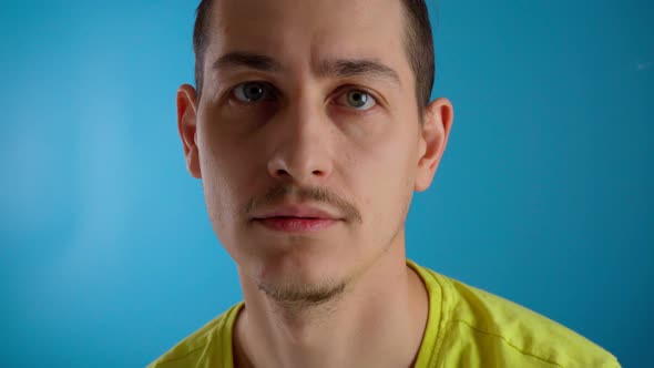 A Young Millennial Guy Says the Word No Blue Background alt